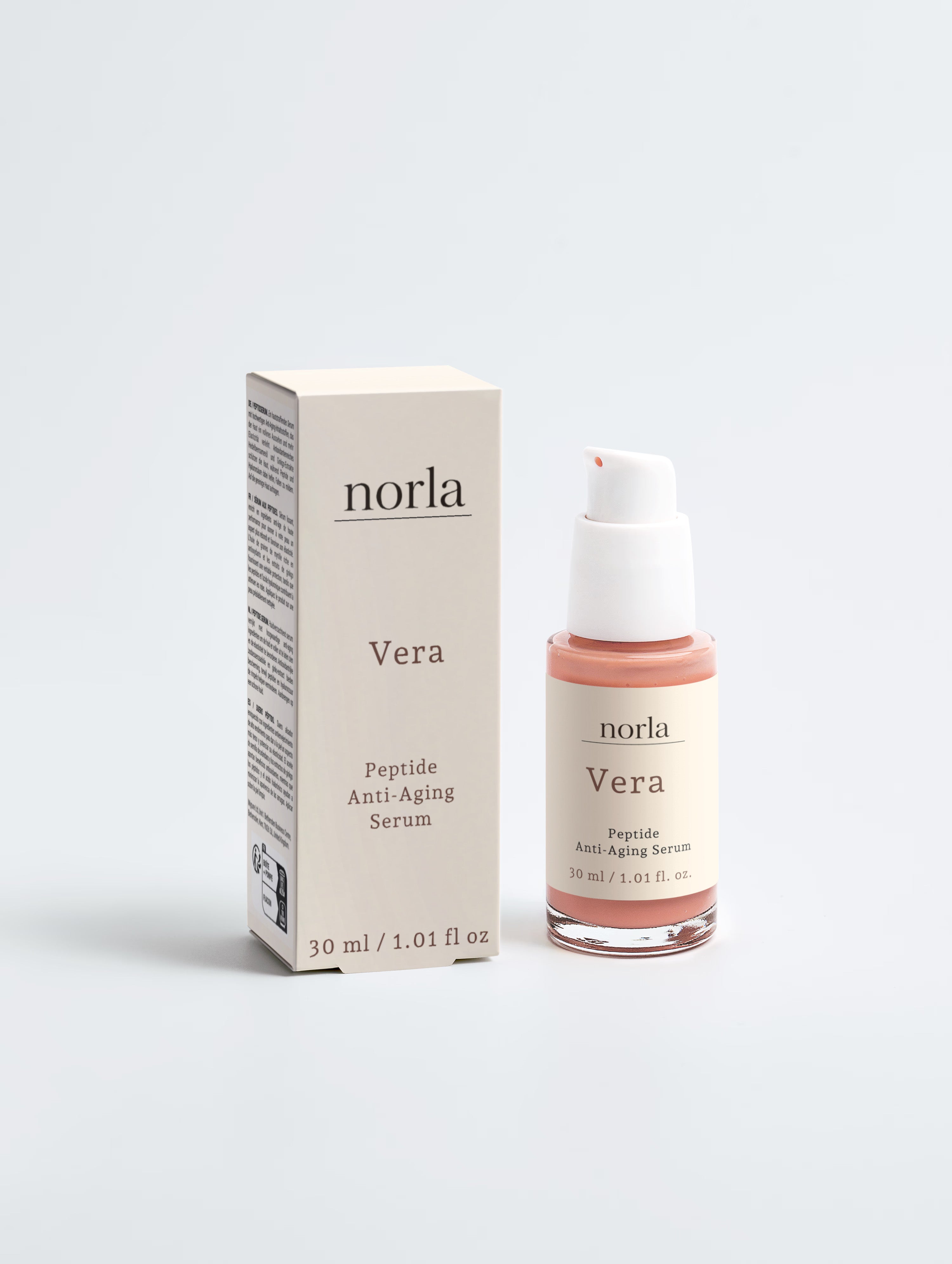 Norla Vera peptide anti-aging serum, 30 ml glass pump bottle with peach-toned serum, beside its cream carton