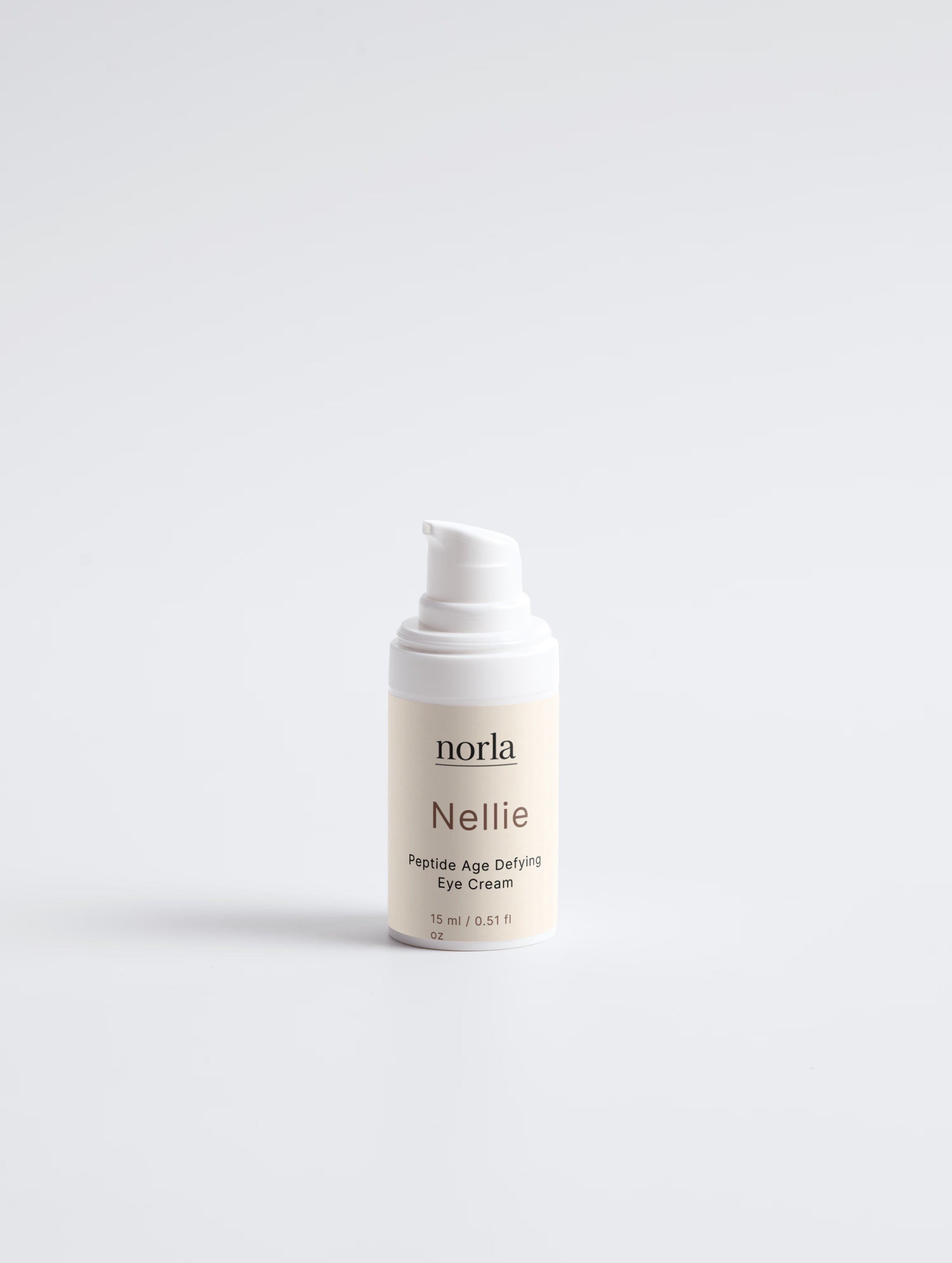 Norla Nellie peptide eye cream, small 15 ml ivory pump bottle on a pale background