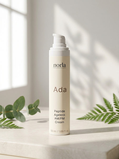 Ada Peptide Ageless AM/PM Cream 50 ml by Norla, airless pump bottle on a marble surface with eucalyptus and fern