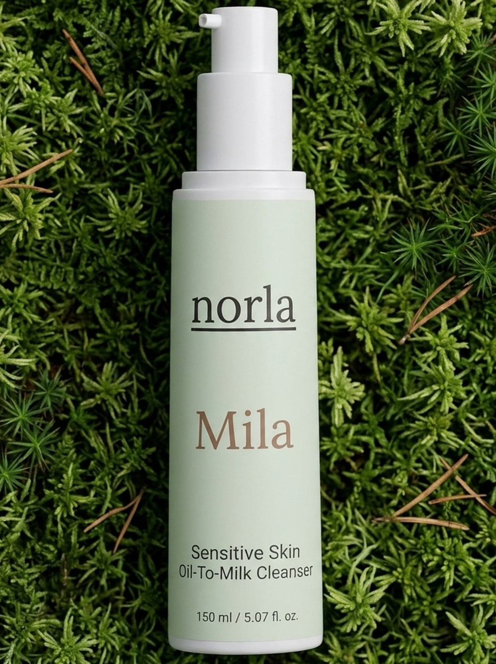 Mila Sensitive Skin Oil-To-Milk Cleanser 150 ml by Norla, bottle lying on green moss